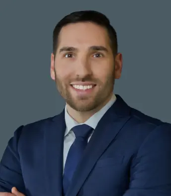 Professional man in a suit smiling at the camera.