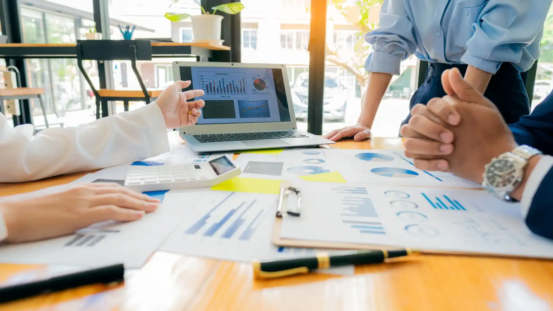 Team discussing business charts and data during a meeting.
