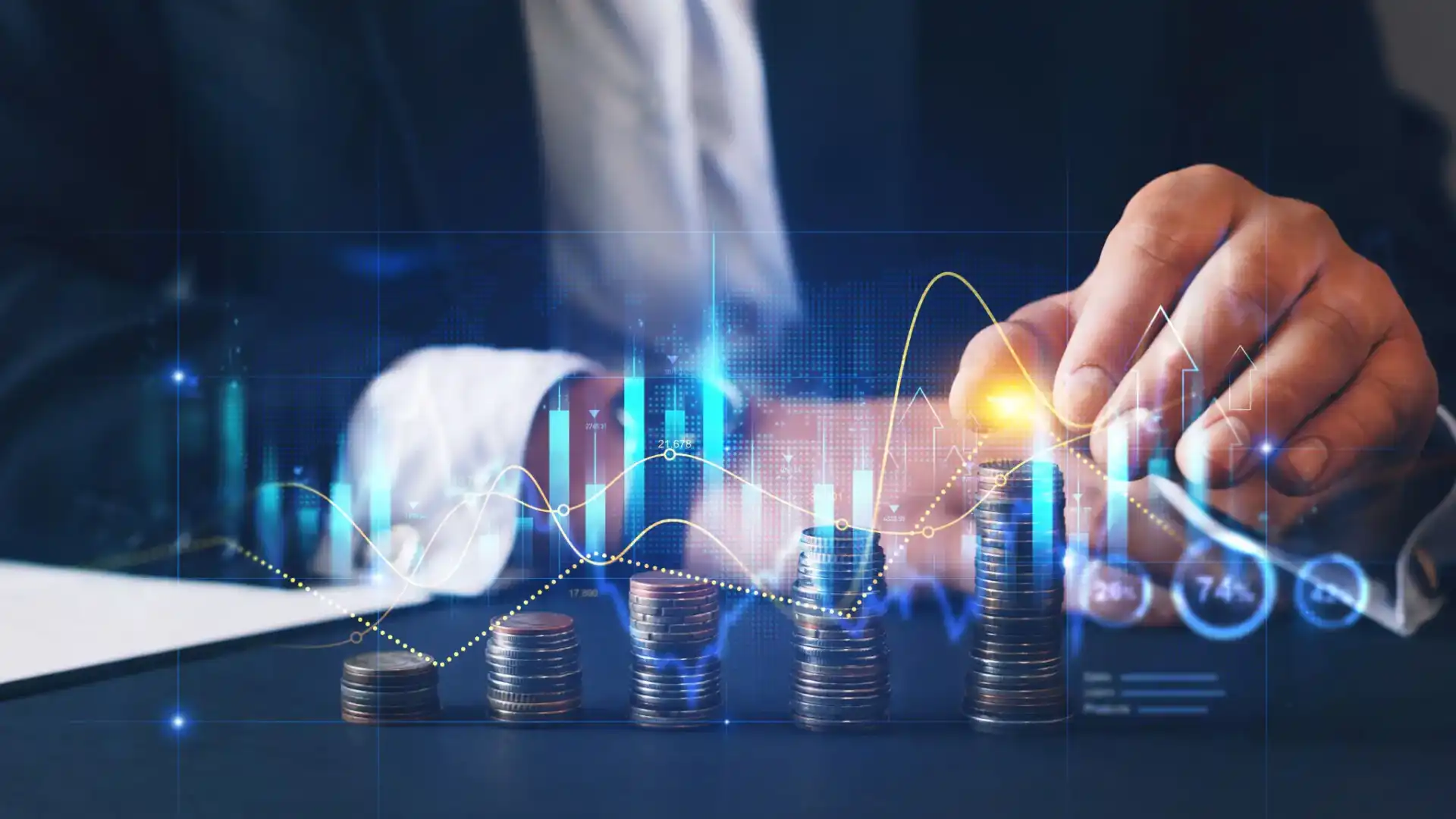Hand stacking coins with digital financial graphs overlay.