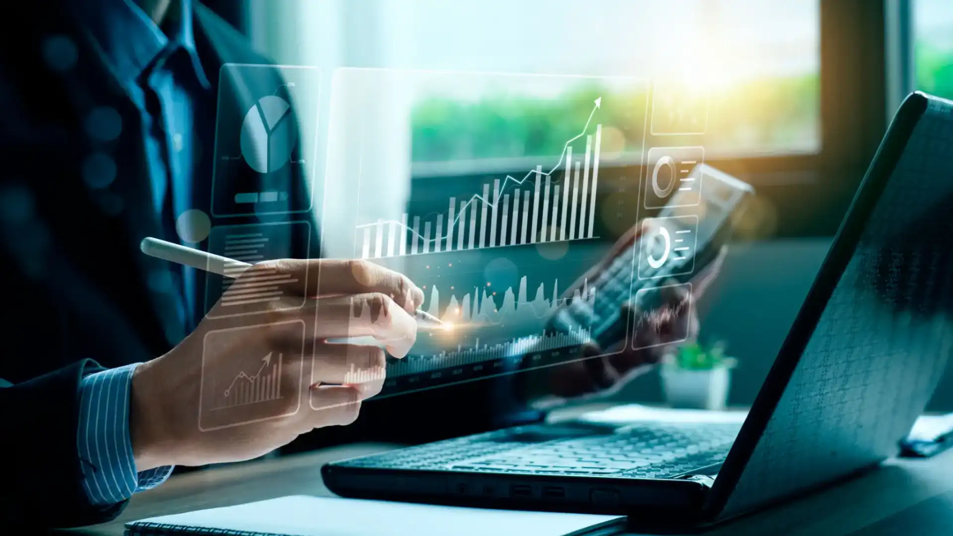 Person analyzing financial data on a transparent digital screen.