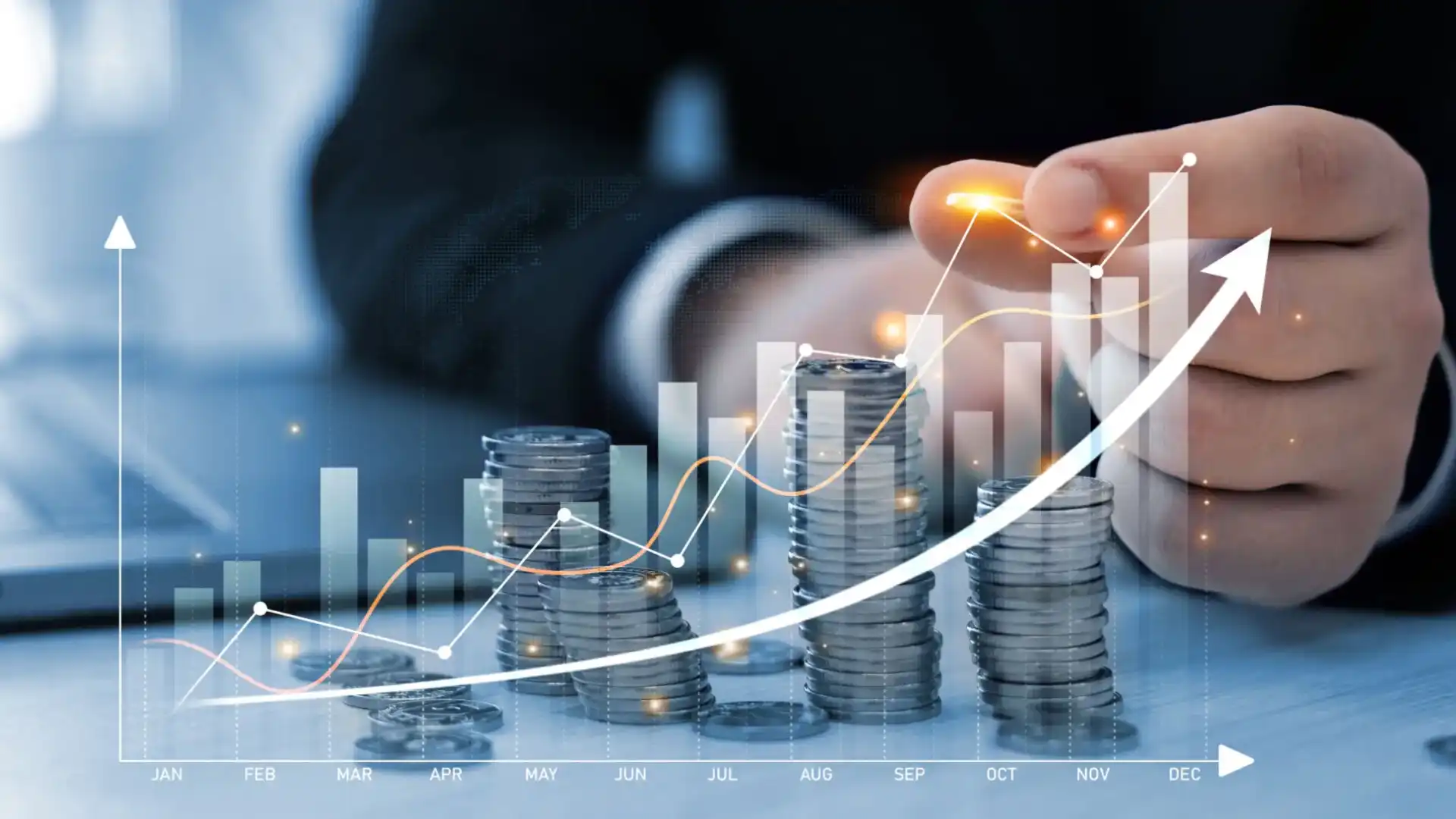 Stacks of coins with rising financial graph and businessman in background.
