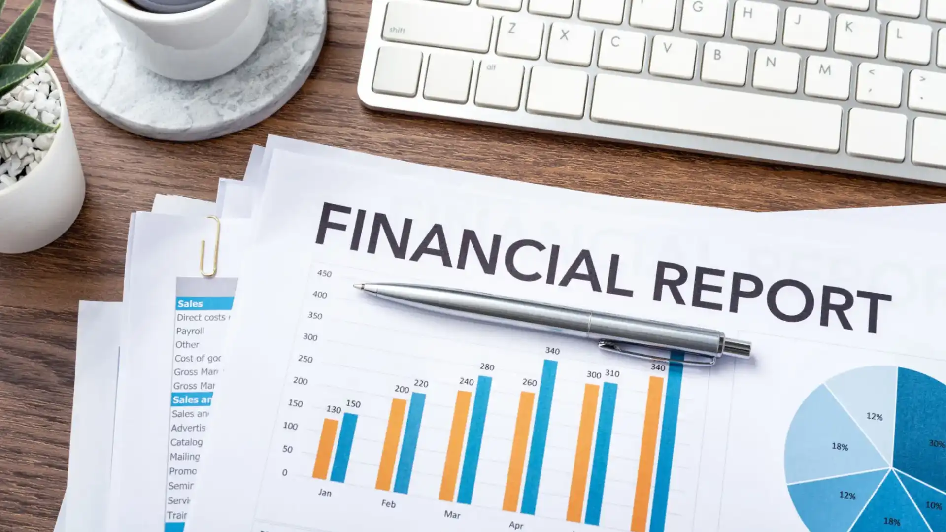 Financial report with colorful bar charts and a pen on a desk.