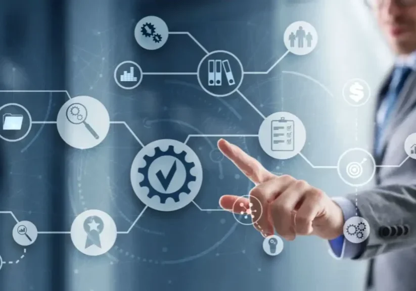 Hand pointing at digital icons representing business and technology concepts.