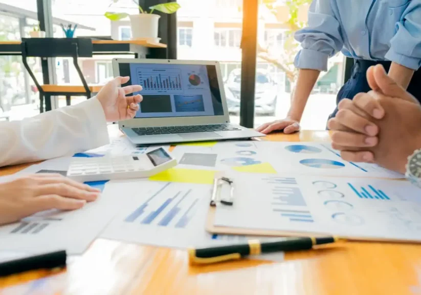 Team discussing business charts and data during a meeting.