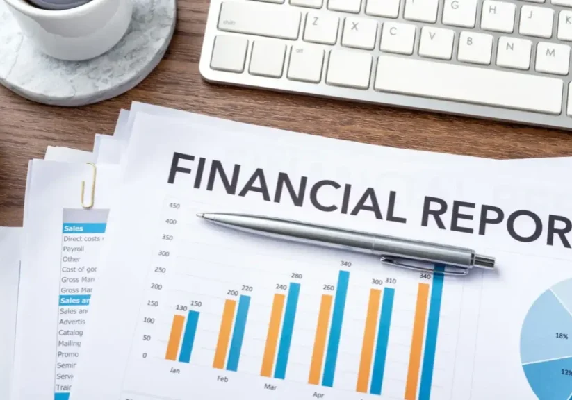 Financial report with colorful bar charts and a pen on a desk.
